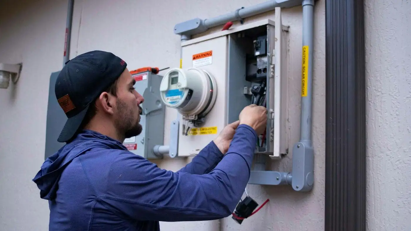 A technician working on an electrical meter on site